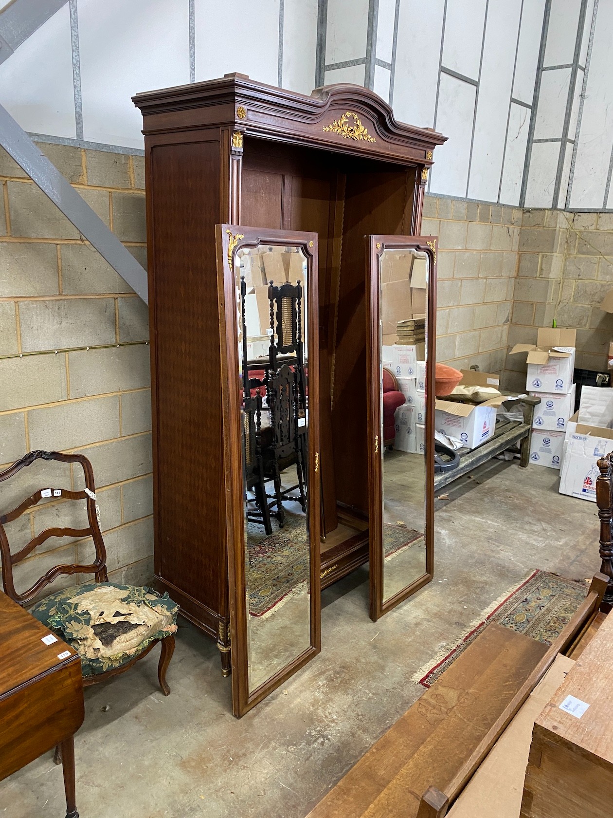 A French gilt metal mounted mirrored armoire, length 134cm, depth 58cm, height 264cm *Please note the sale commences at 9am.